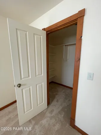 a large kitchen with a large counter top a sink stainless steel appliances and cabinets