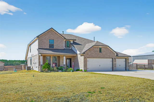 a front view of a house with a yard and a garage