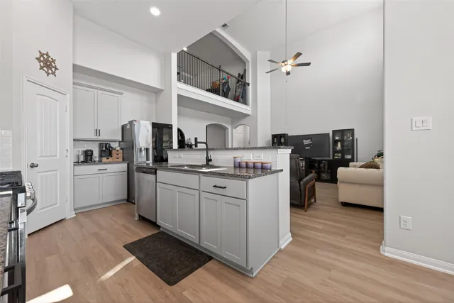 a kitchen with sink cabinets and refrigerator