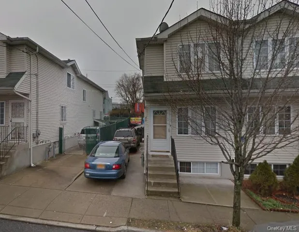 a car parked in front of white house