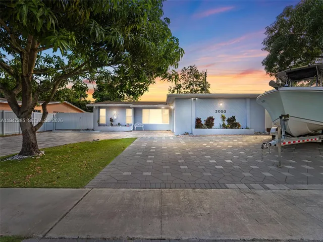 a front view of a house with a yard and a garage