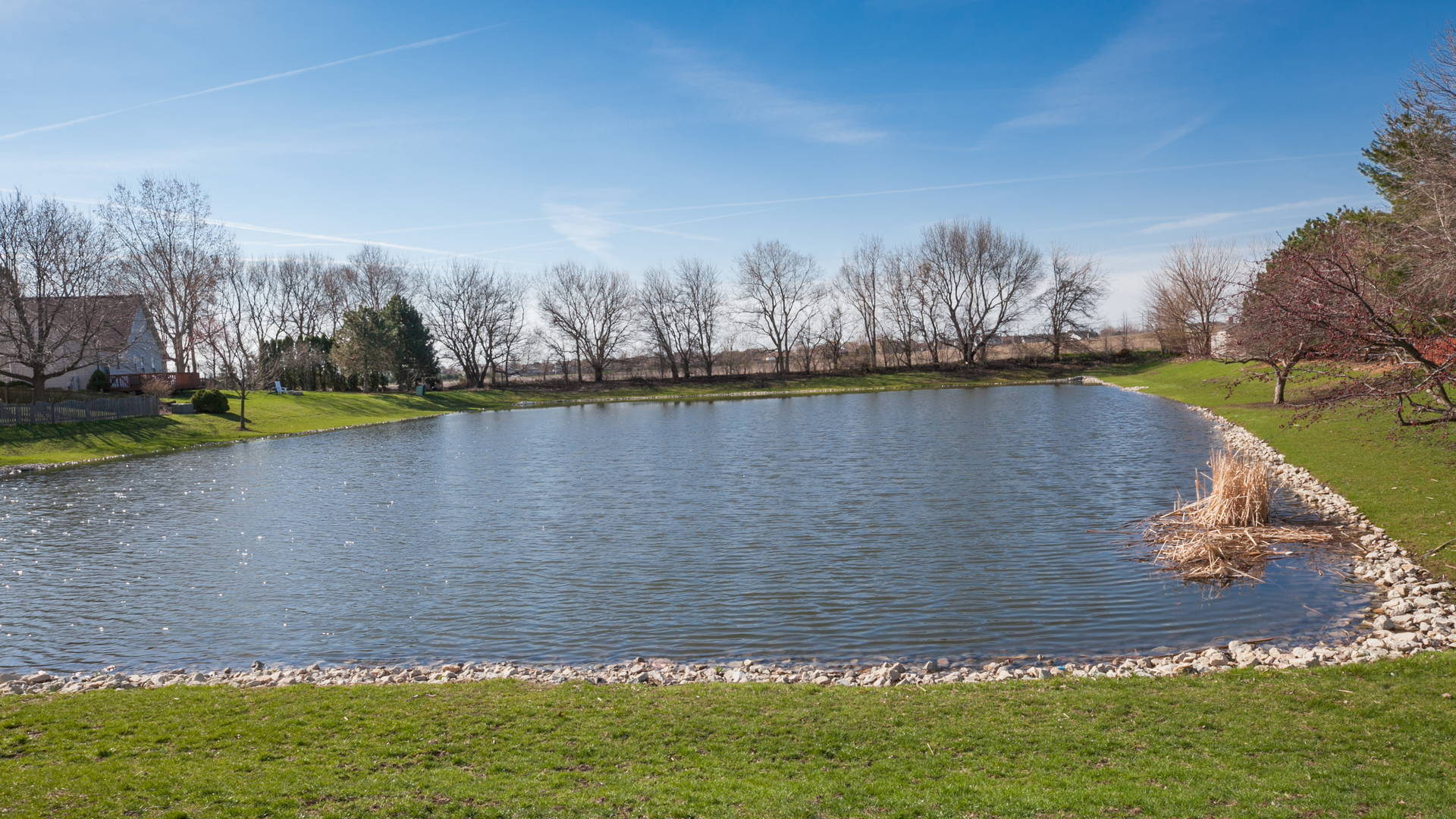 1850 Carrier Circle Plainfield, IL 60586 - Photo 13 of 13 a view of a lake with houses in the back