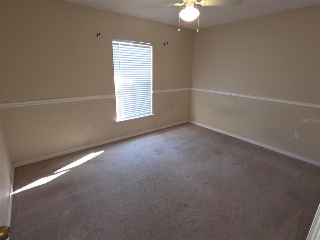 10563 Marysville Street Spring Hill, FL 34608 - Photo 14 of 22 an empty room with windows and fan
