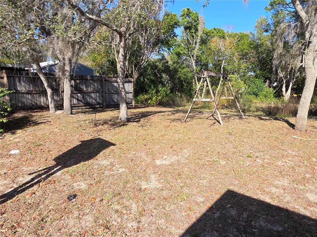 10563 Marysville Street Spring Hill, FL 34608 - Photo 20 of 22 a view of a yard with trees