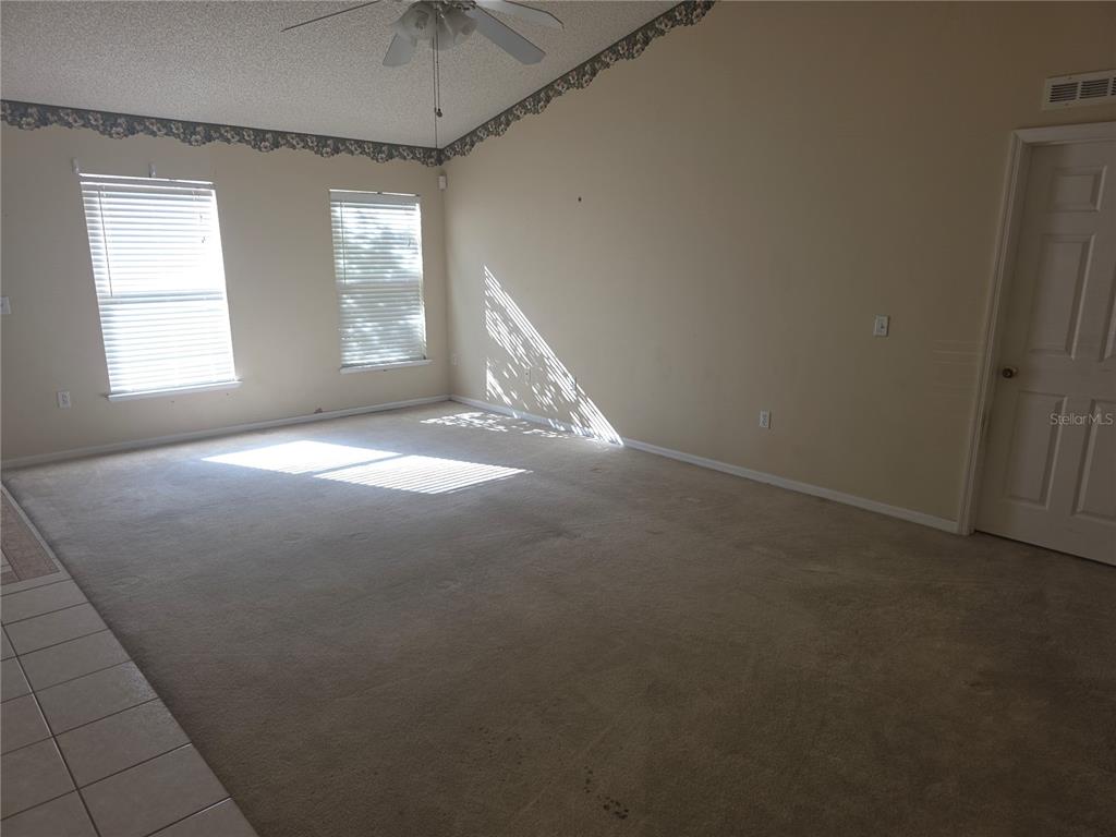 10563 Marysville Street Spring Hill, FL 34608 - Photo 7 of 22 an empty room with windows and ceiling fan