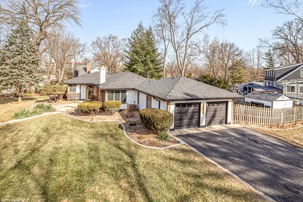 a front view of a house with yard patio and garage