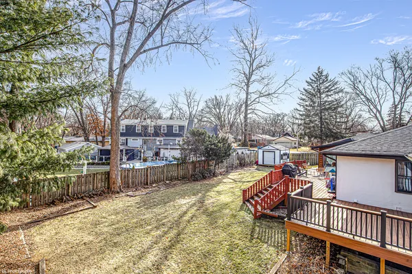a view of a chairs and tables in the back yard of the house