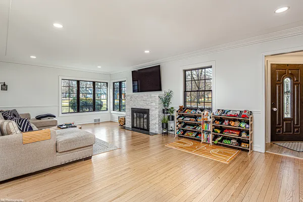 a living room with fireplace furniture and a flat screen tv