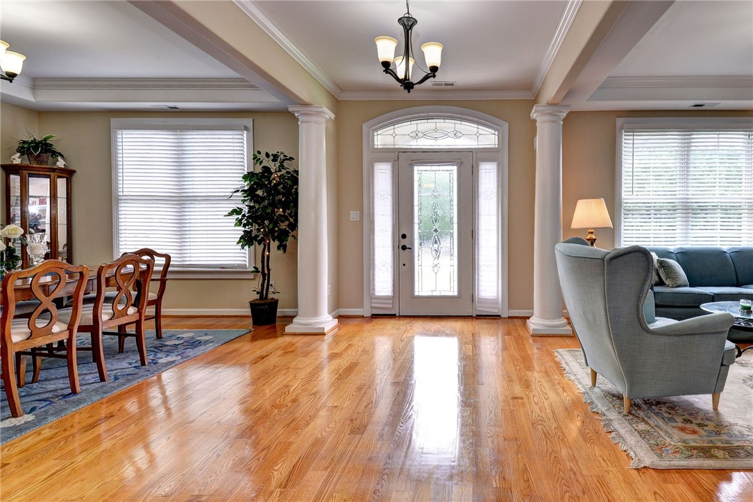 11 Butler Farm Road Hampton, VA 23666 - Photo 9 of 39 Foyer entrance featuring crown molding, a chandelier, light wood-style floors, and ornate columns