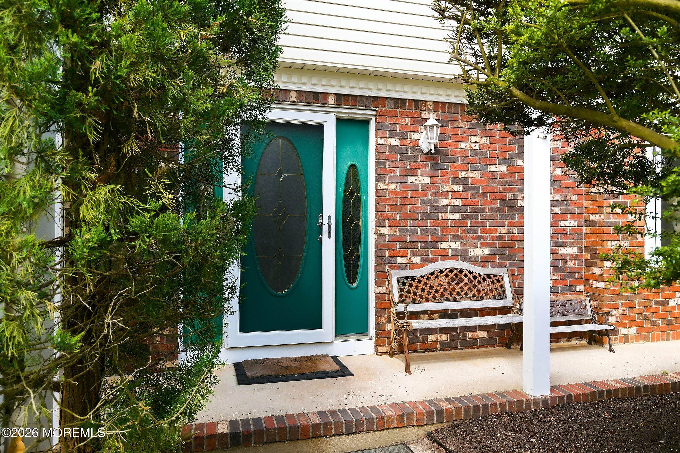 822 York Road Brick, NJ 08724 - Photo 4 of 37 a small garden with a bench in front of a house