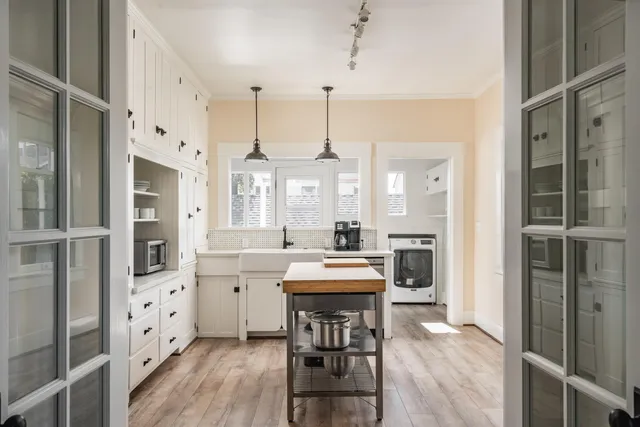 a large kitchen with a table and chairs