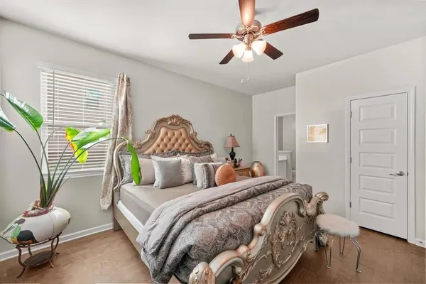 a bedroom with a bed a chandelier and a couch