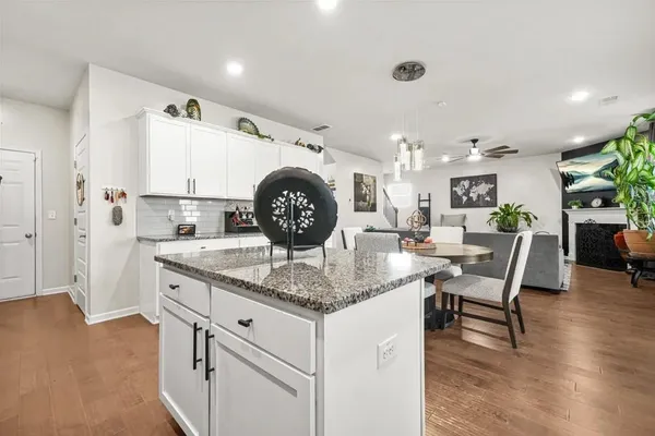 a kitchen with stainless steel appliances granite countertop a stove and a refrigerator