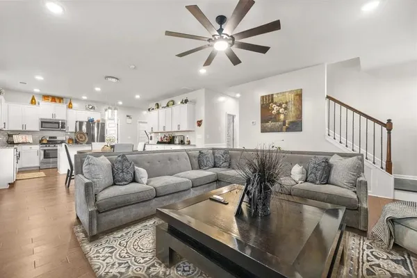 a living room with furniture and kitchen view