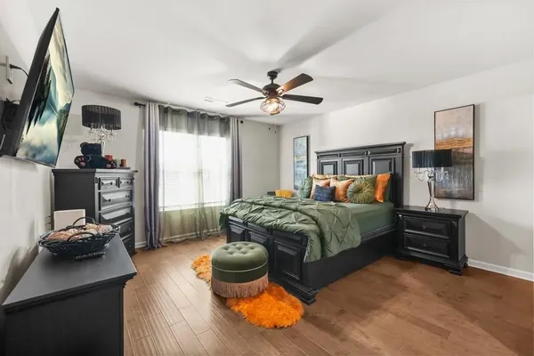 a bedroom with a bed and wooden floor