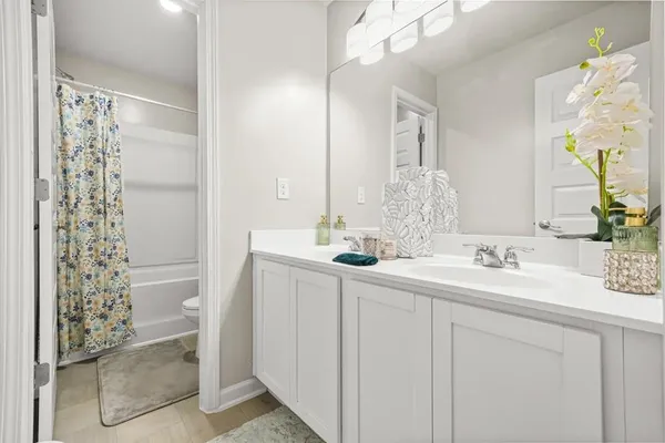 a bathroom with a double vanity sink mirror and shower