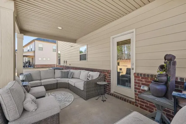 a view of a white house with a yard and large tree