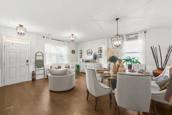 a living room with furniture and a chandelier
