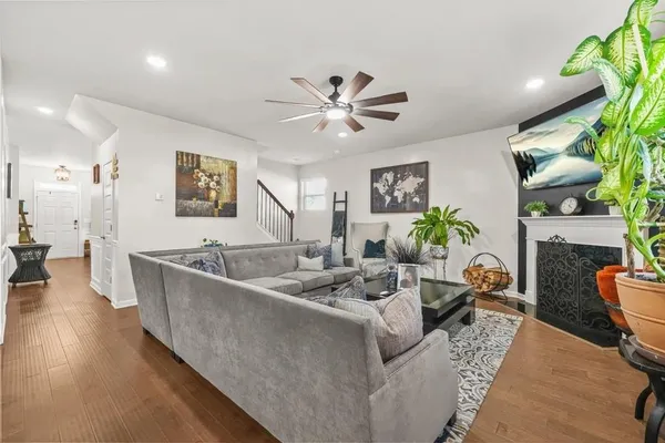 a living room with furniture and a potted plant