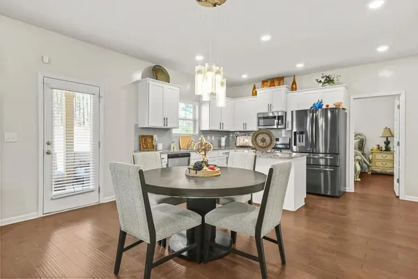 a view of a dining room with furniture and a wooden floor