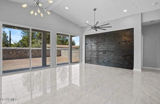 a view of an empty room with glass door