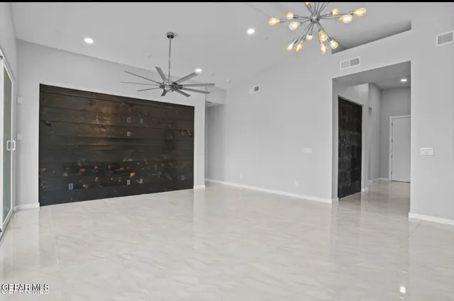 a view of a livingroom with a ceiling fan and window