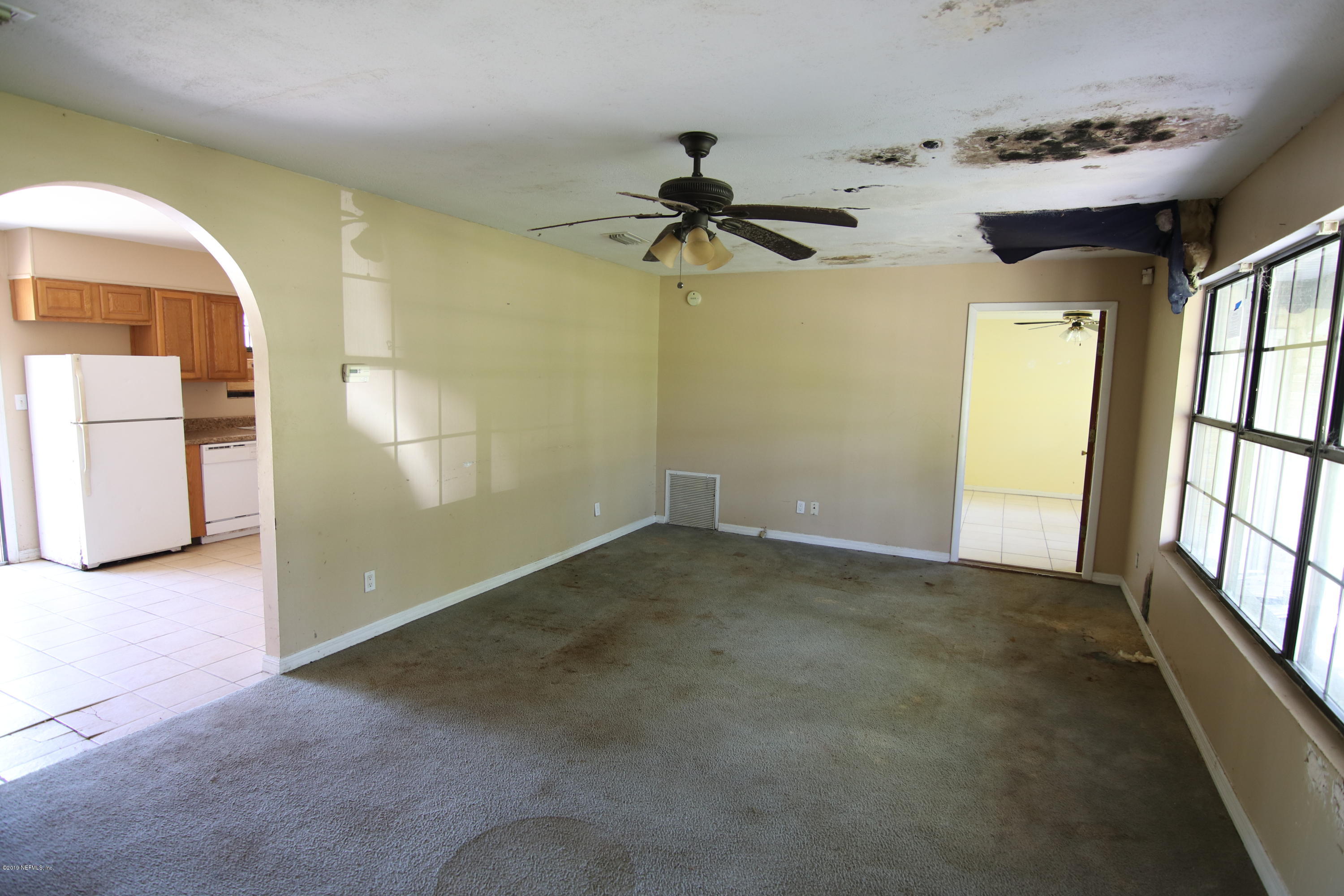 54344 Hurst Road Callahan, FL 32011 - Photo 26 of 55 en empty room with windows and ceiling fan