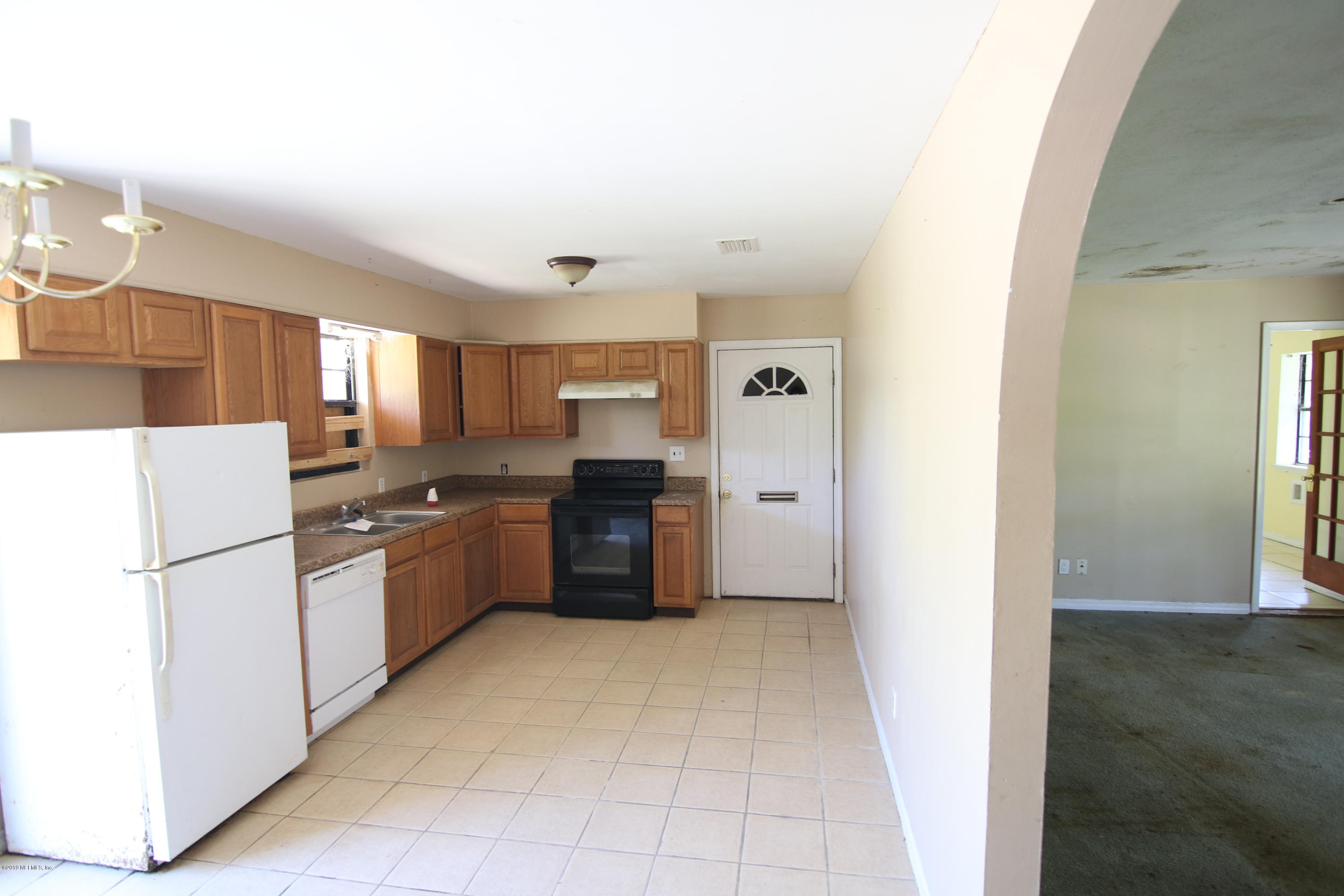 54344 Hurst Road Callahan, FL 32011 - Photo 30 of 55 a kitchen with granite countertop a refrigerator and a stove