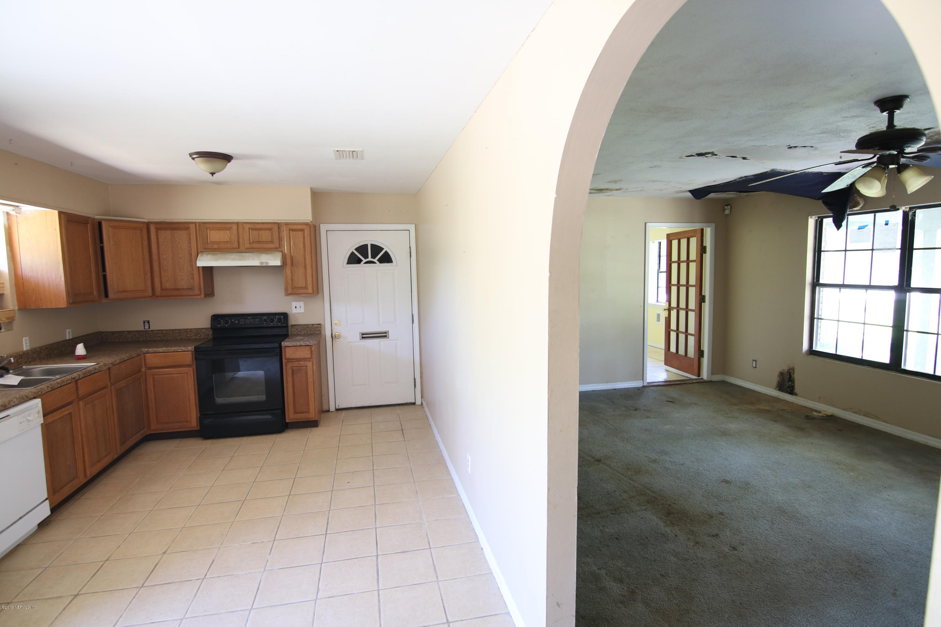 54344 Hurst Road Callahan, FL 32011 - Photo 31 of 55 a kitchen with granite countertop a refrigerator and a stove top oven