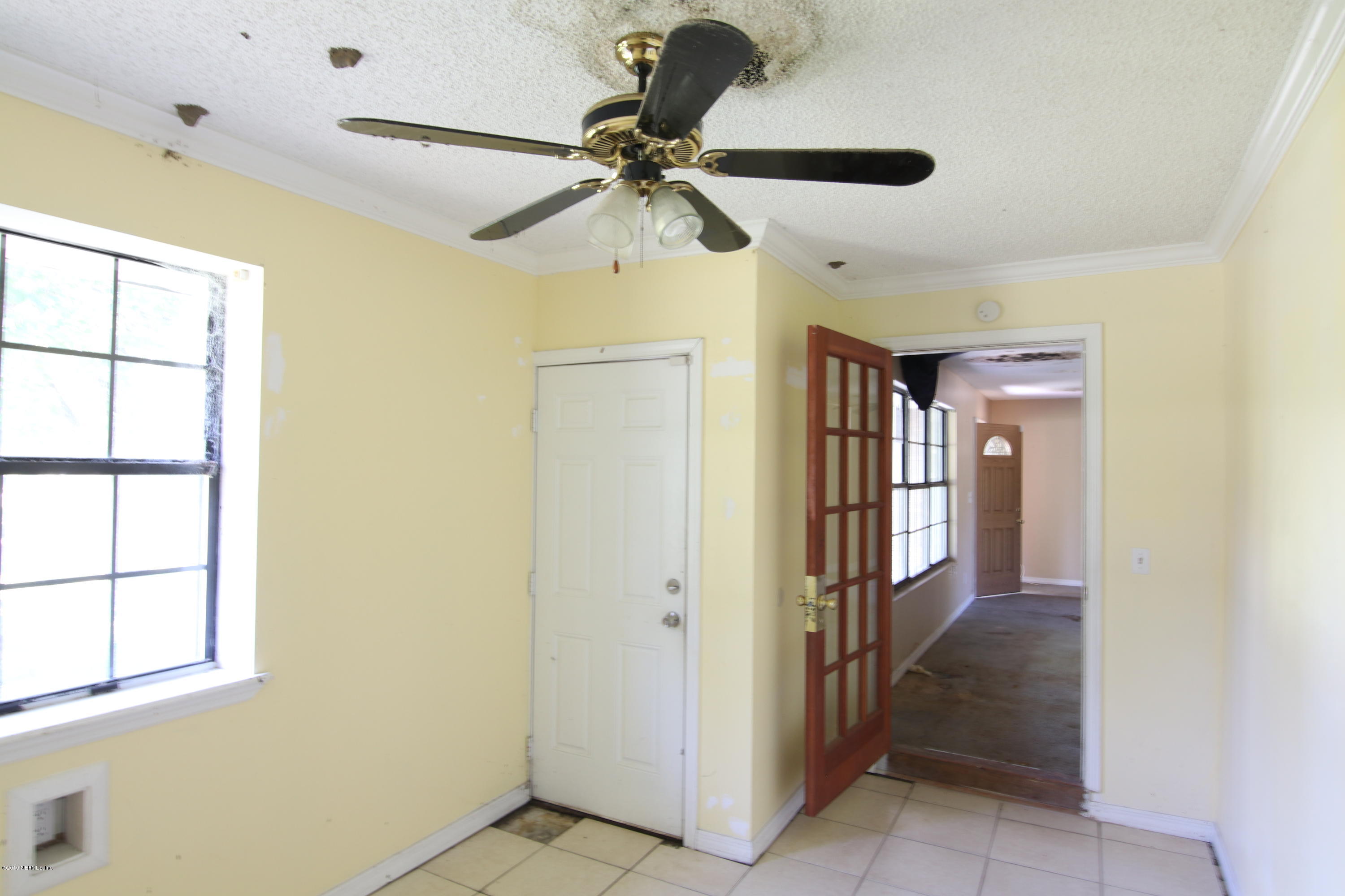 54344 Hurst Road Callahan, FL 32011 - Photo 47 of 55 a view of a hallway with a window and a chandelier fan