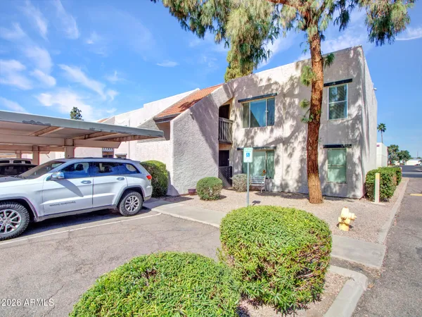 a view of a brick house with a yard