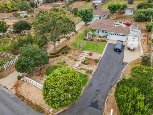 an aerial view of a house with a yard and garden
