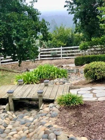 a view of a house with a backyard and a garden