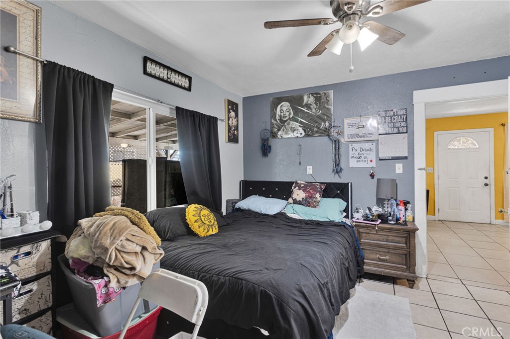 1132 Calhoun Street Redlands, CA 92374 - Photo 13 of 27 a bedroom with a bed and ceiling fan