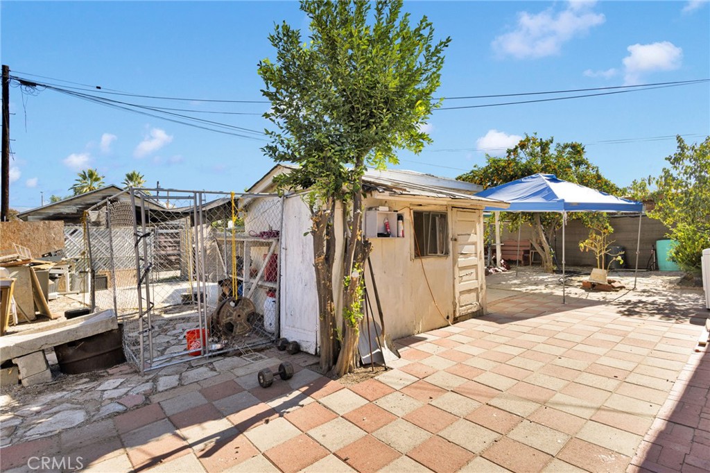 1132 Calhoun Street Redlands, CA 92374 - Photo 24 of 27 a patio with a table and chairs under an umbrella