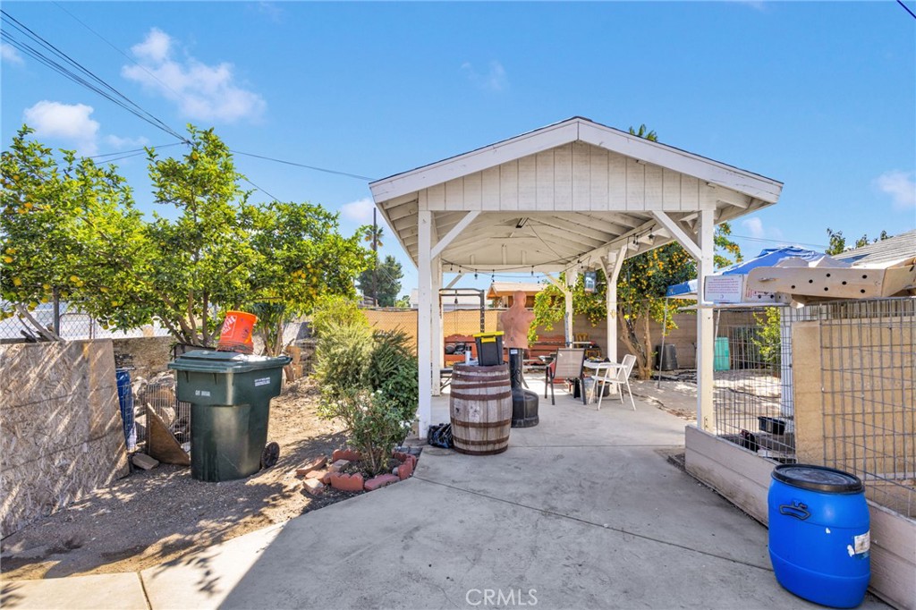 1132 Calhoun Street Redlands, CA 92374 - Photo 26 of 27 a view of a patio with table and chairs under an umbrella