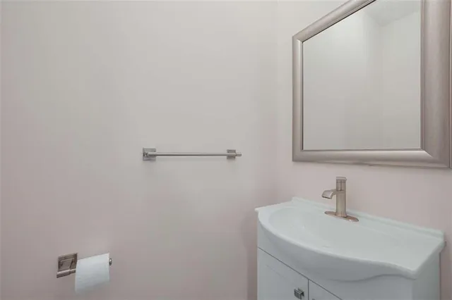 a bathroom with a sink a mirror and vanity