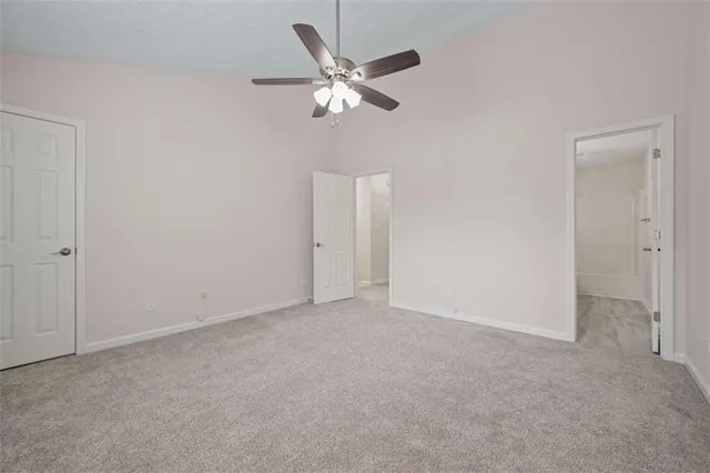 a view of an empty room with a ceiling fan