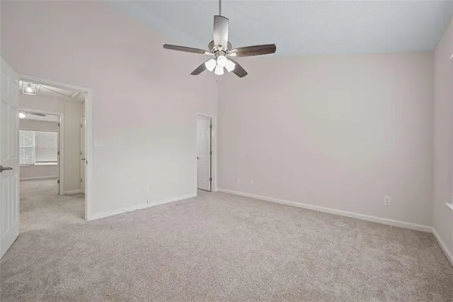 a view of a chandelier in big room and chandelier fan