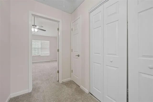 an empty room with closet and mirror