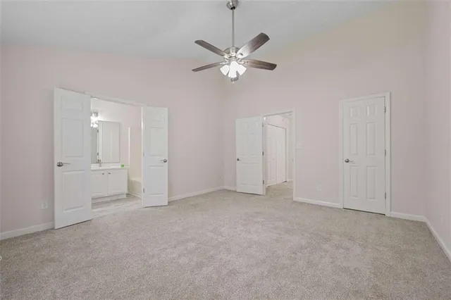 a view of a livingroom with a ceiling fan and window