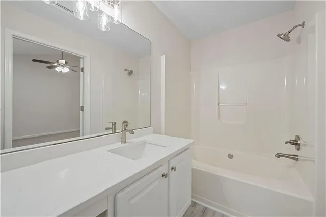 a bathroom with a sink a mirror and a bathtub