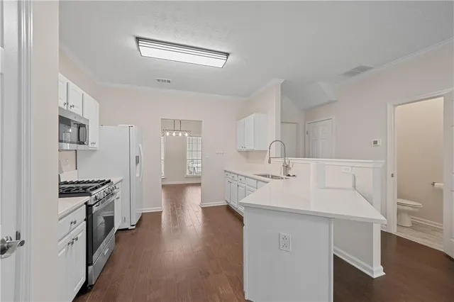 a kitchen with a sink stove and cabinets
