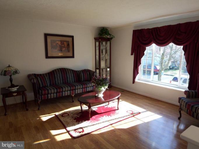 8060 Athena Street Springfield, VA 22153 - Photo 3 of 21 a living room with furniture and wooden floor