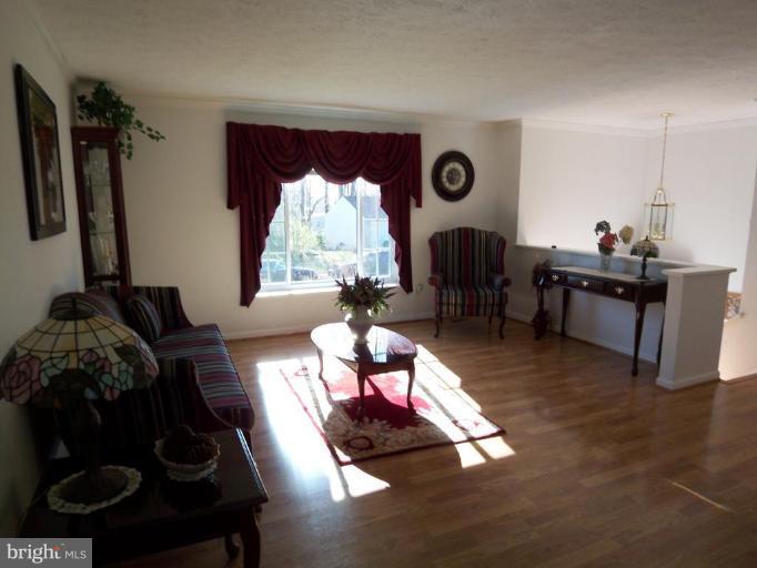 8060 Athena Street Springfield, VA 22153 - Photo 4 of 21 a living room with furniture and a window