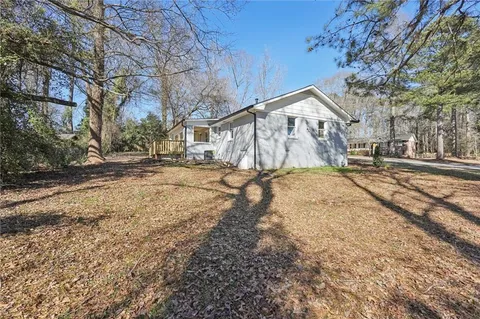 a front view of a house with a yard covered in snow