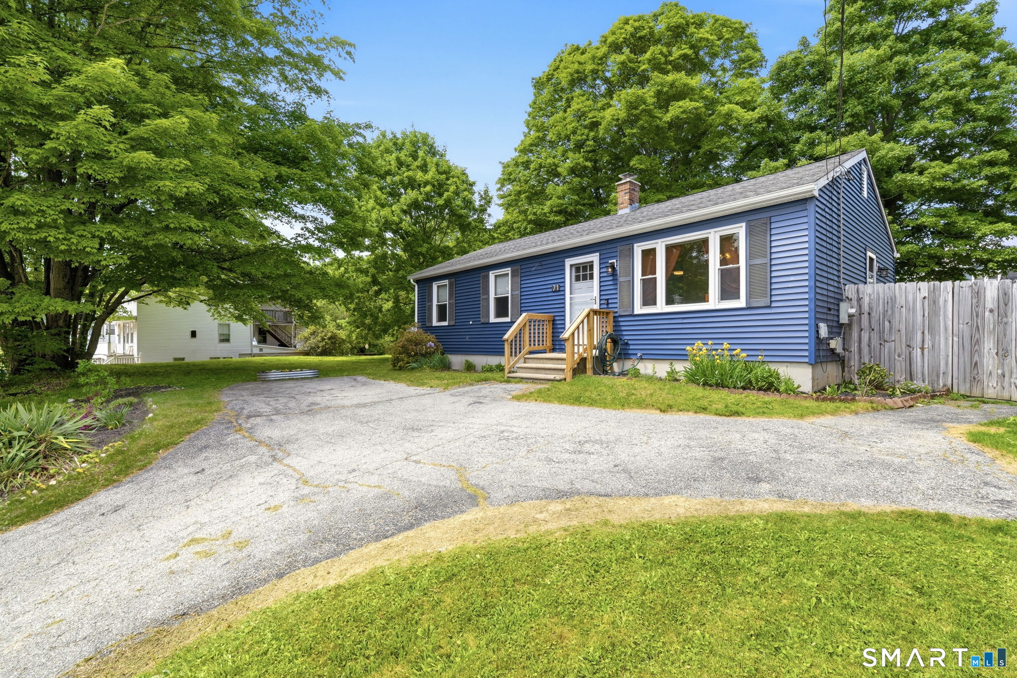 71 Smith Street Putnam, CT 06260 - Photo 23 of 25 a front view of a house with garden