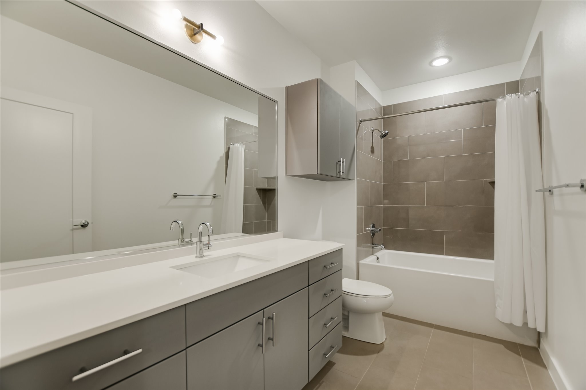 4801 Springdale Road, Unit 1207 Austin, TX 78723 - Photo 8 of 10 Full bath with vanity, shower / tub combo with curtain, and light tile patterned floors