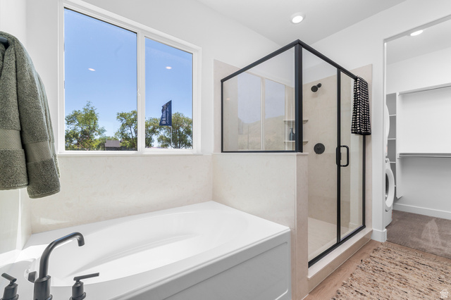 1352 West 2350 South, Unit 18 Perry, UT 84302 - Photo 14 of 26 Contemporary bathroom featuring a built-in soaking tub with matte black fixtures