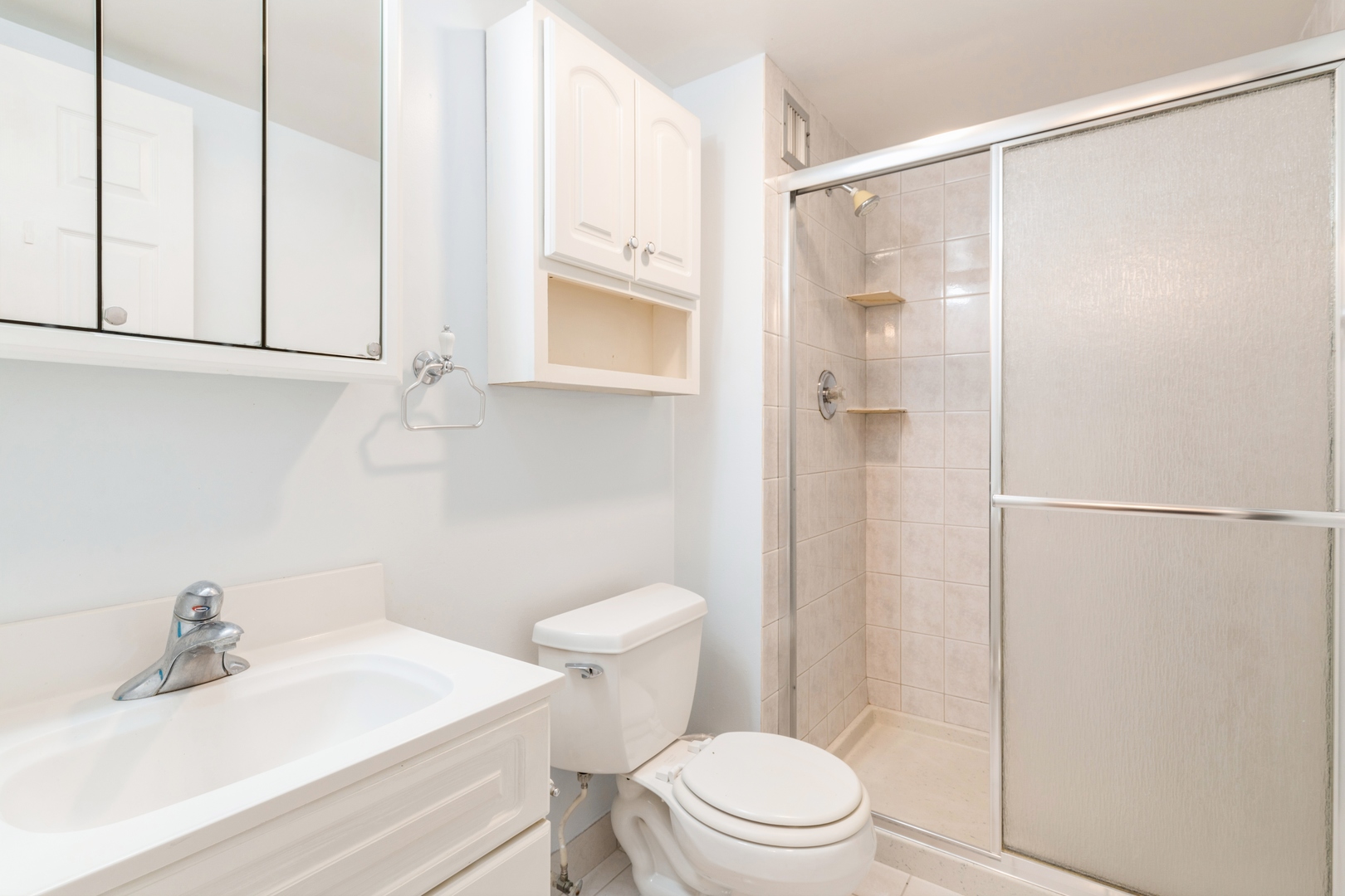 9701 North Dee Road, Unit 5M Niles, IL 60714 - Photo 12 of 21 a bathroom with a sink a toilet and shower